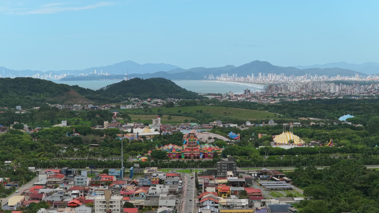 Aerial panoramic view of Beto Carrero World theme park and Penha city with Balneario Camboriu skyline in background, tourism and leisure