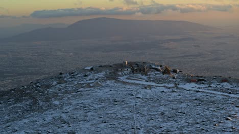 aerial - snowy mountain - city of athens in the background at dusk - shot on dji inspire 2 x7 50mm raw