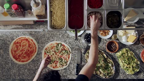 preparing vegetarian pizza in restaurant kitchen