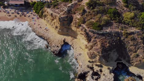 Drone-shot-from-the-cliffs-by-the-coastline-in-Lagos,-Algarve