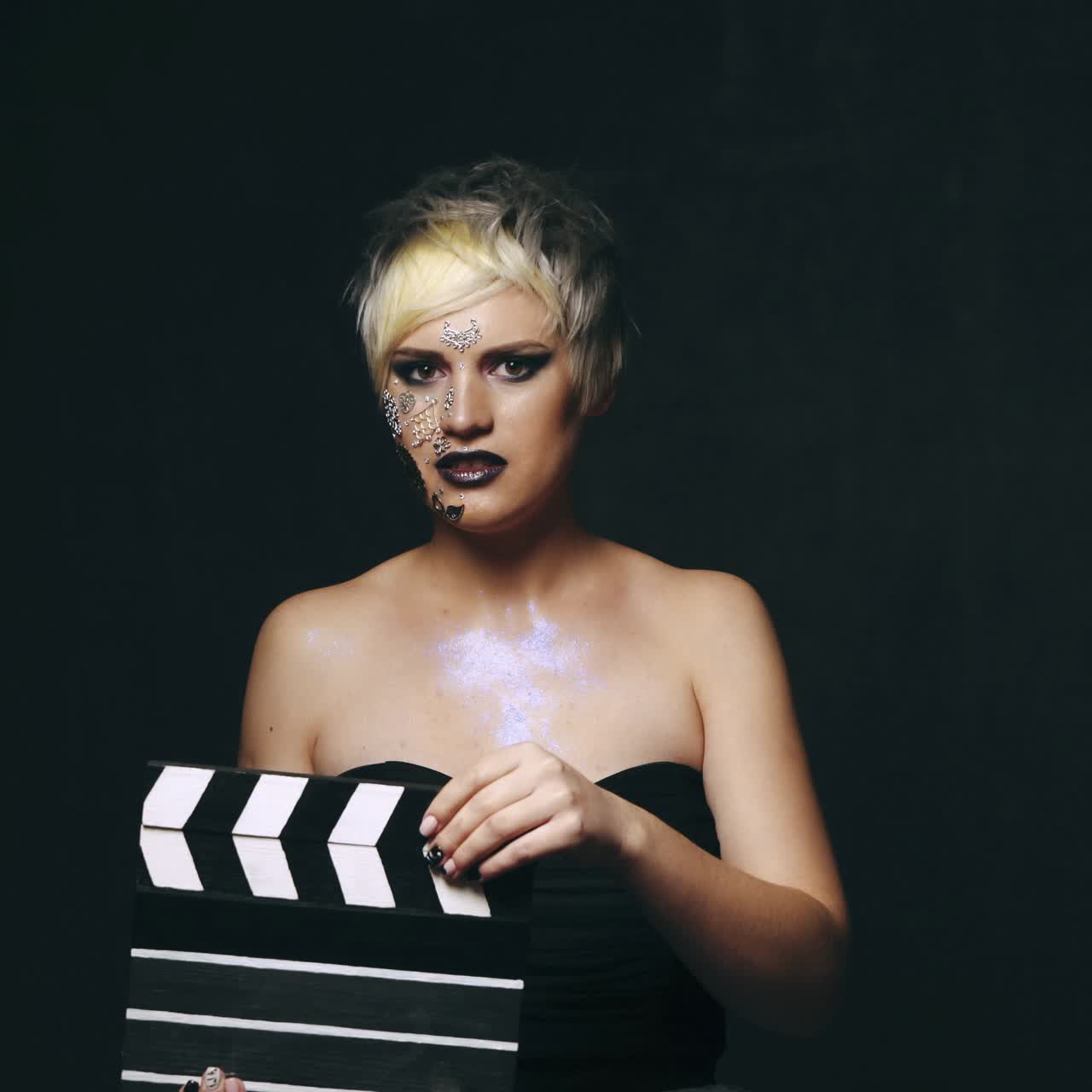 Woman with movie clapboard