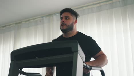 young hansome man training on treadmill machine workout in the gym