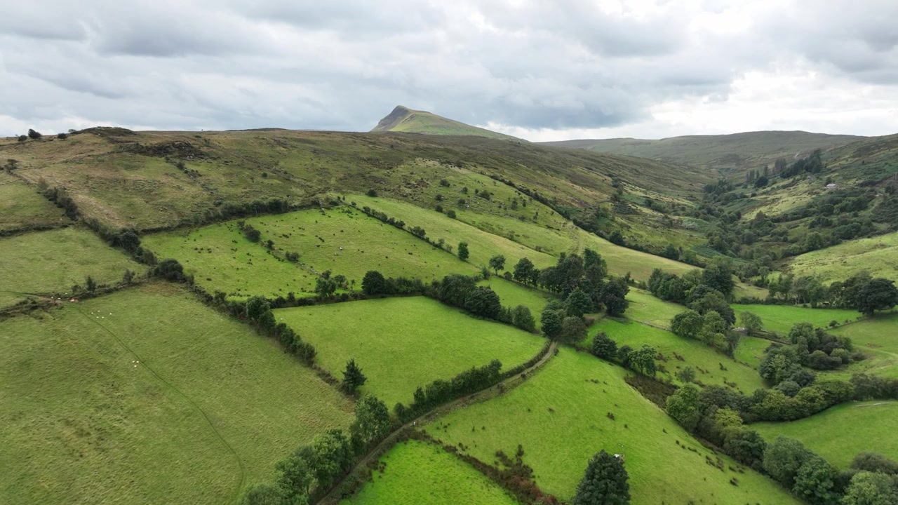 Le verdi valli dell'Irlanda, Glens of Antrim, prati verdi lussureggianti sotto un cielo estivo nuvoloso, cuore agricolo