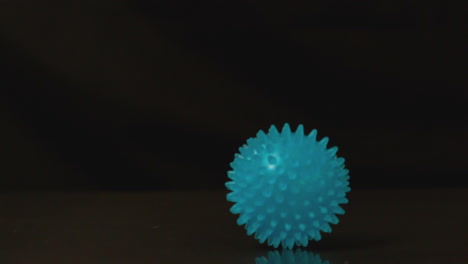 massage ball rolling across black surface