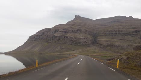 pov driving the icelandic ring road with a stunning landscape view on a cloudy day - iceland