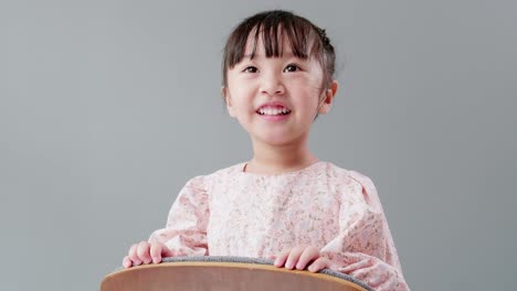 Child-emerging-in-the-framing-holding-on-the-back-of-armchair