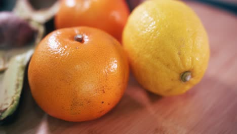 Close-Spinner-Shot-of-a-Lemon-Followed-By-Oranges-and-Two-Halves-of-Avocado-One-With-a-Big-Stone-and-Green-Flesh