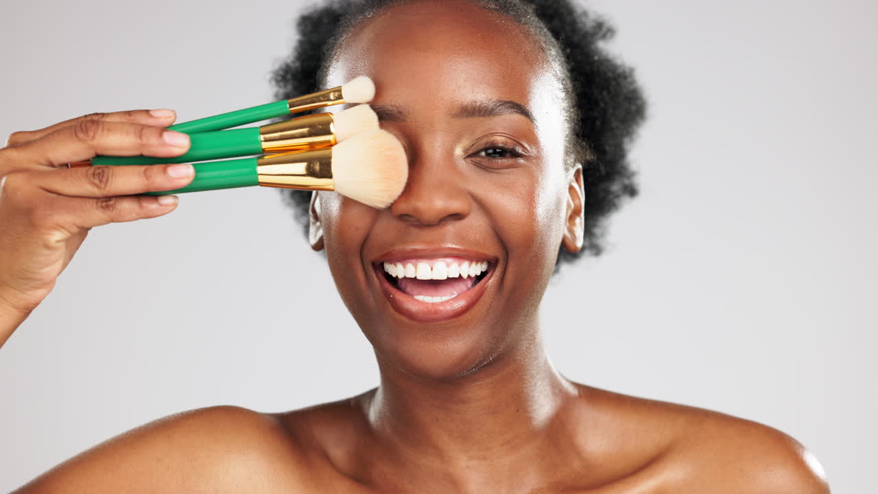Face makeup, smile and black woman with brushes