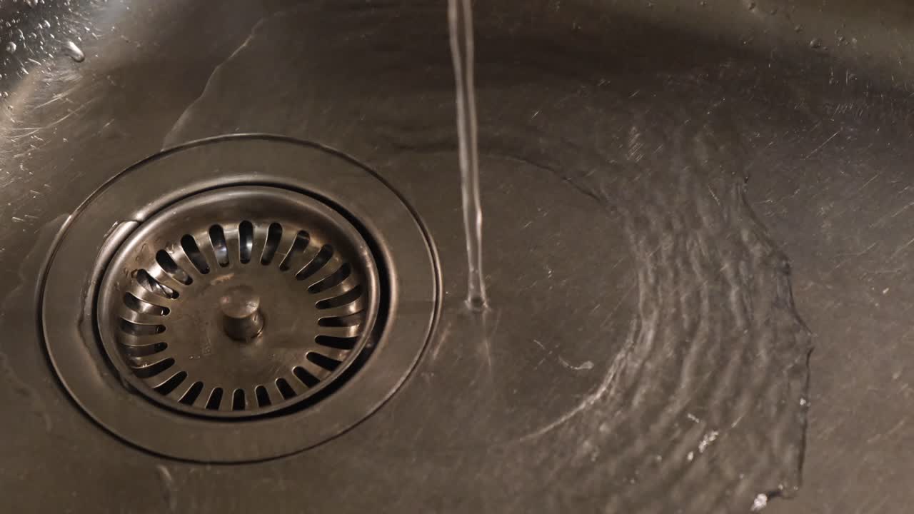 Water flowing into a kitchen sink drain