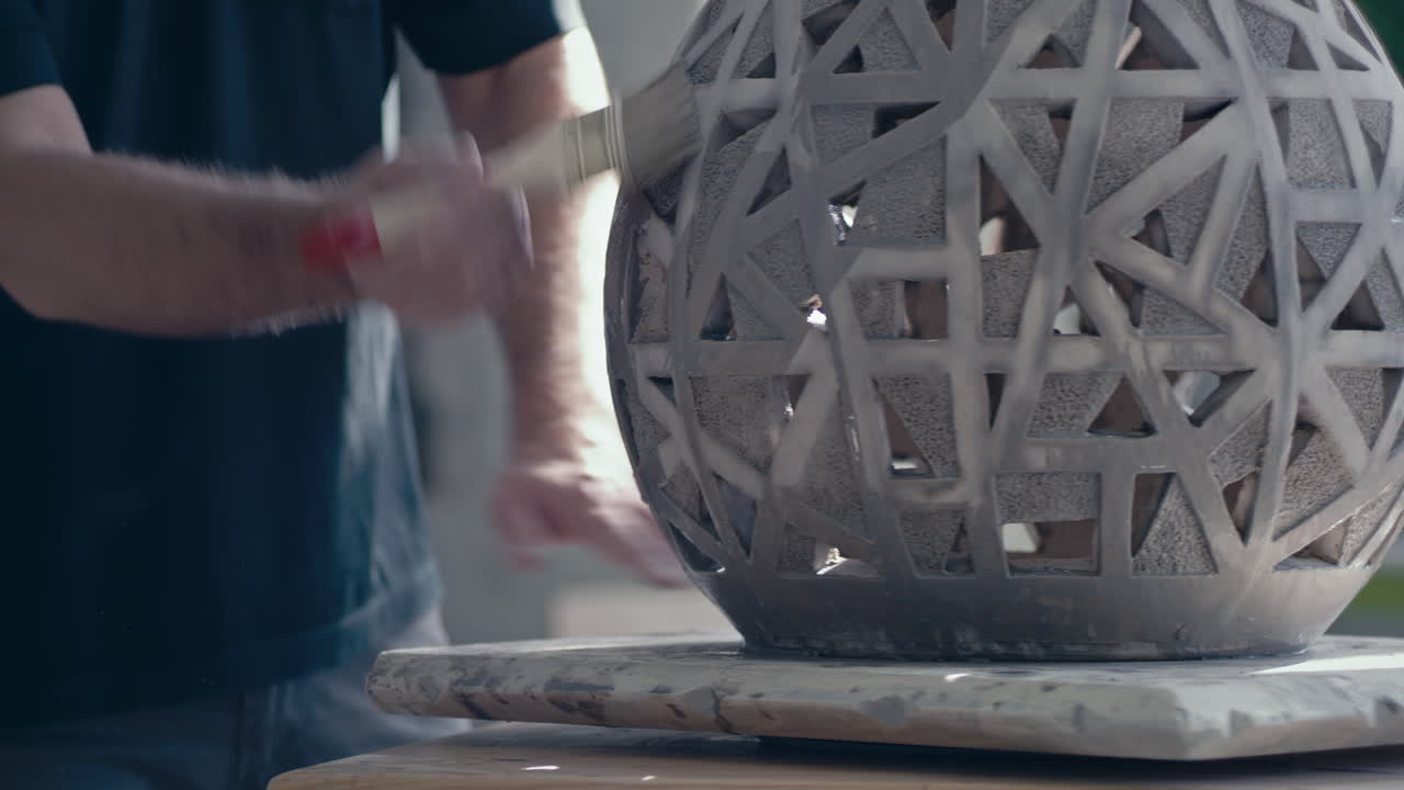 Artisan working on a decorative ceramic piece