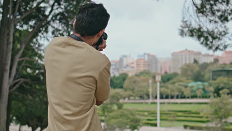 guy taking picture town view on professional camera. unrecognizable photographer