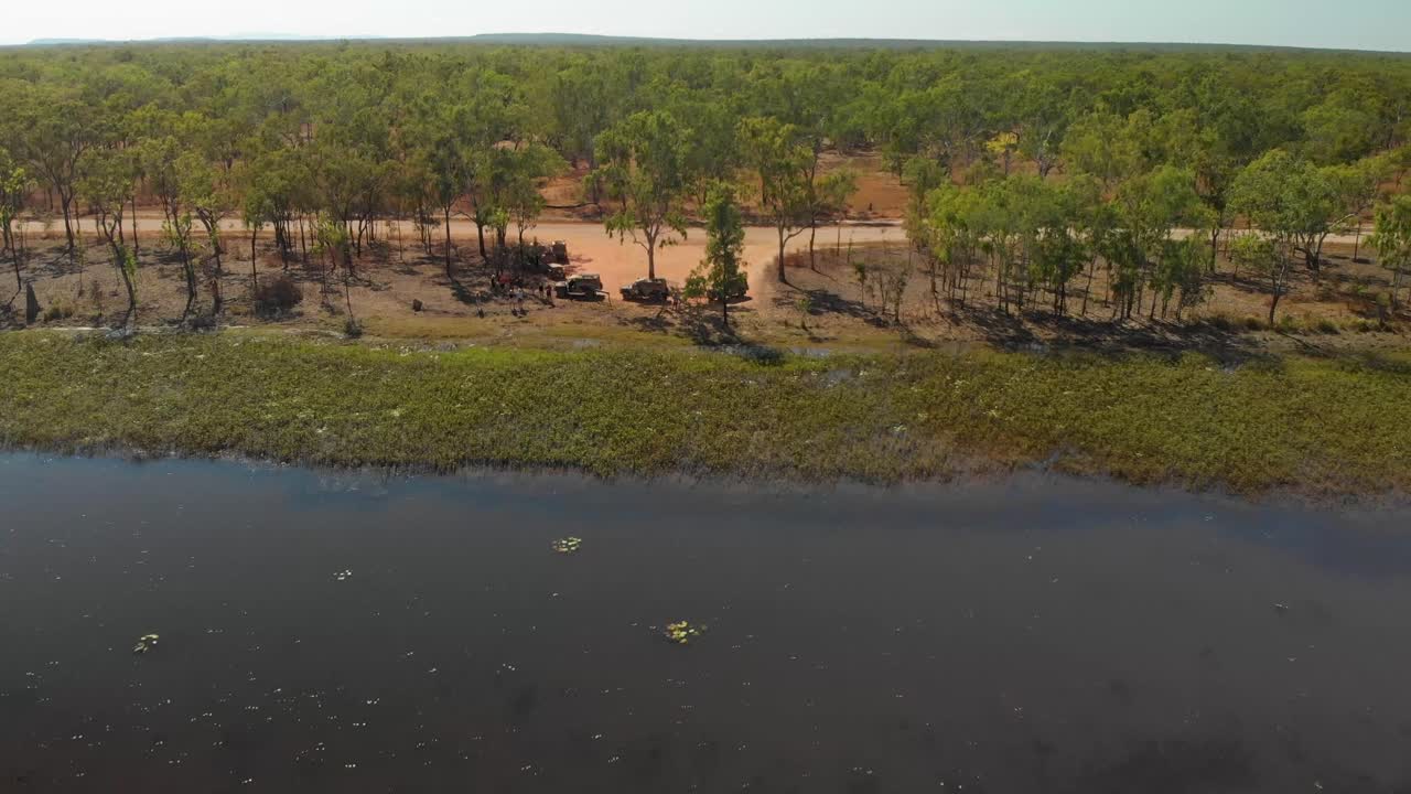 Wetland Landscape with Vehicles and People