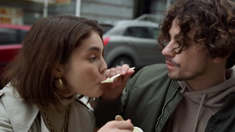 lovely couple enjoying ice cream on street. pair spending date outdoor.