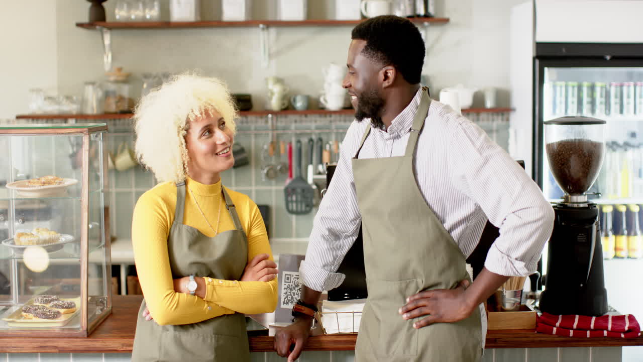 A diverse barista team co-workers share a moment in a cozy cafe