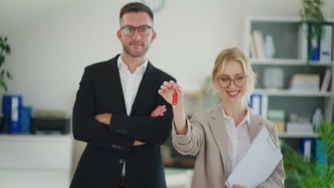 real estate agent rejoices holding keys to new apartments