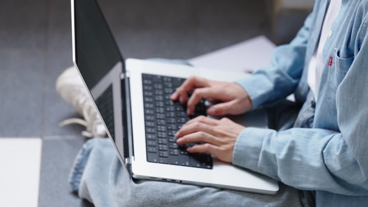 Two Asian girls student partners are working on a laptop help study together