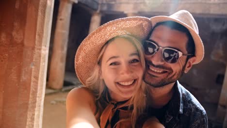 young tourists couple taking selfies together at ancient roman monument