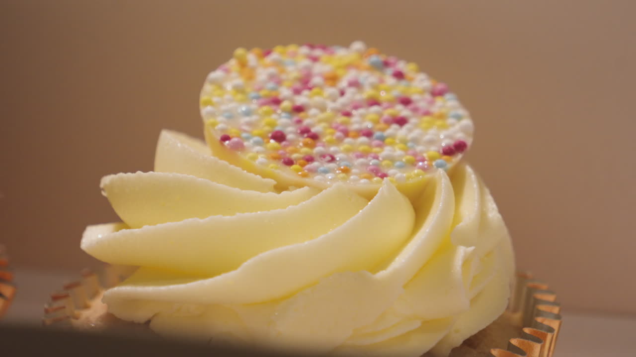 White Chocolate Cupcake in Box Ready to Eat with Colorful Topping. Close Up Snack Dessert Food Photography