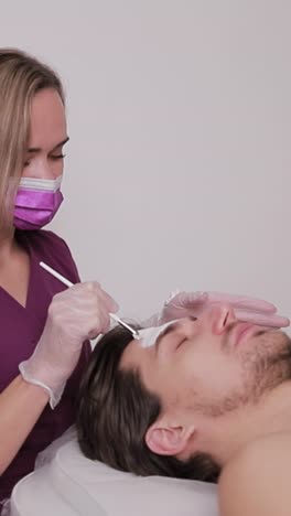 man receiving a facial treatment