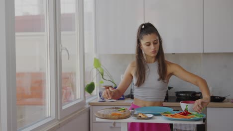 young woman chopping fresh vegetables in a bright kitchen
