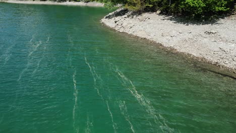 beautiful crystal clear waters at shore of klontalersee lake,switzerland