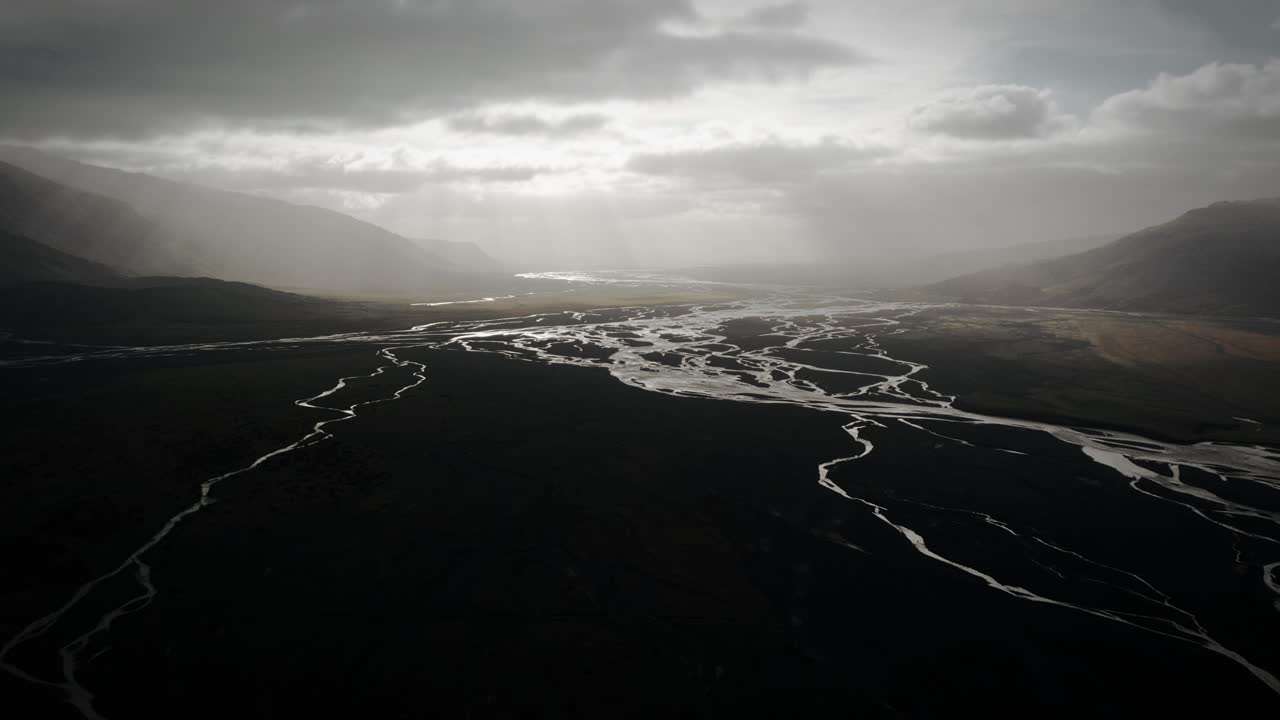 Epic aerial thor valley, glacial river flowing through black volcanic floodplain, thorsm&ouml;rk dramatic moody landscape Iceland