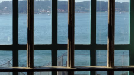 alcatraz prison, metal bars on window and barbed wire on external fence, california usa