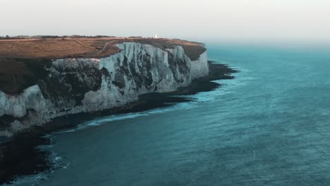 golden hour circle around the white cliffs of dover, sunlight grazing the tops