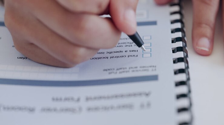 Person Filling Out a Checklist