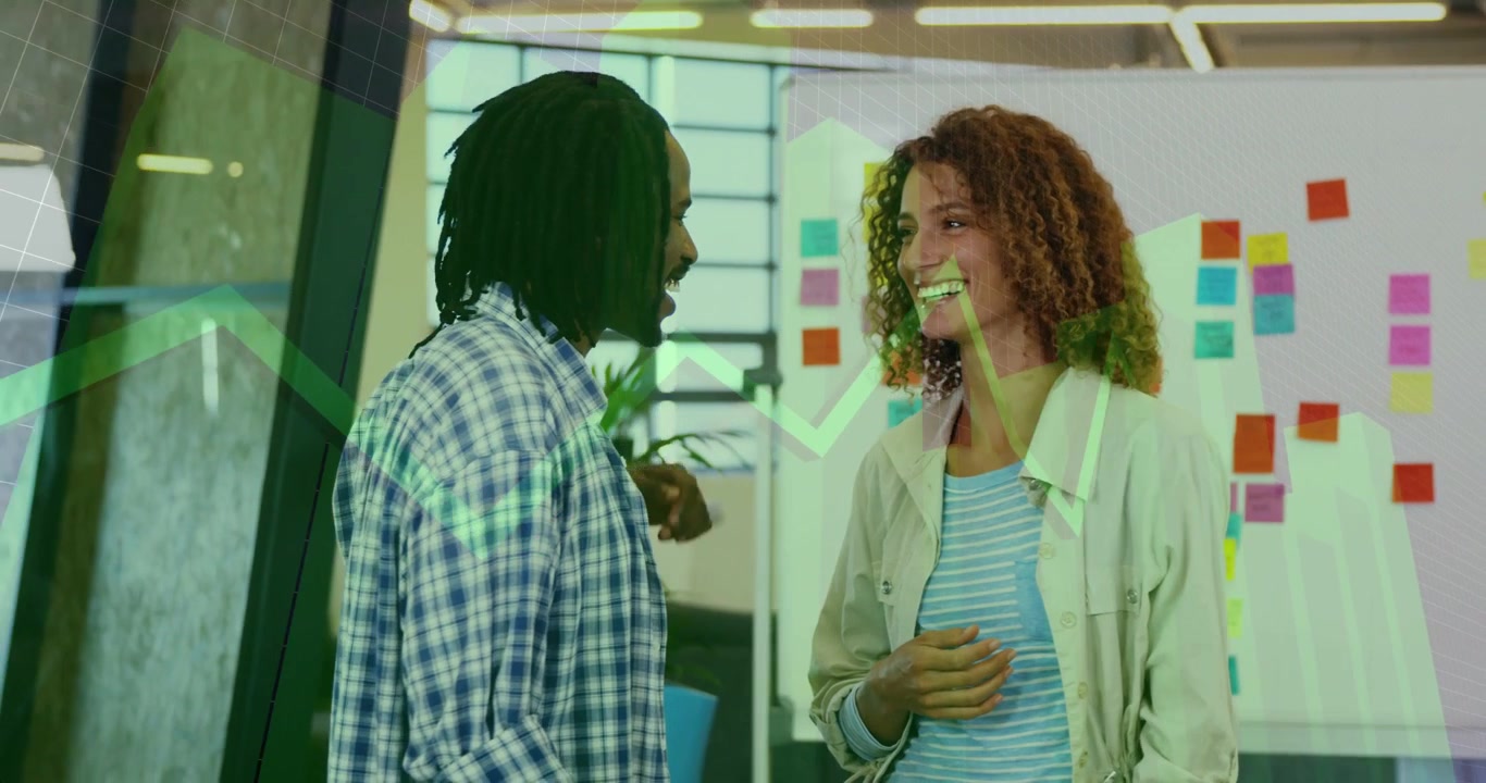 Vertical video: Man and woman talking, causing green graph overlay over notes for business planning