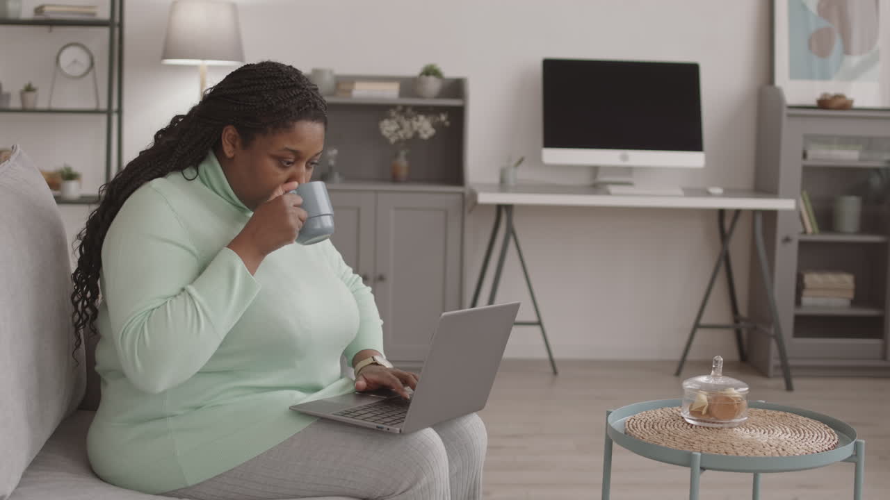 African-American Businesswoman Working and Drinking Coffee