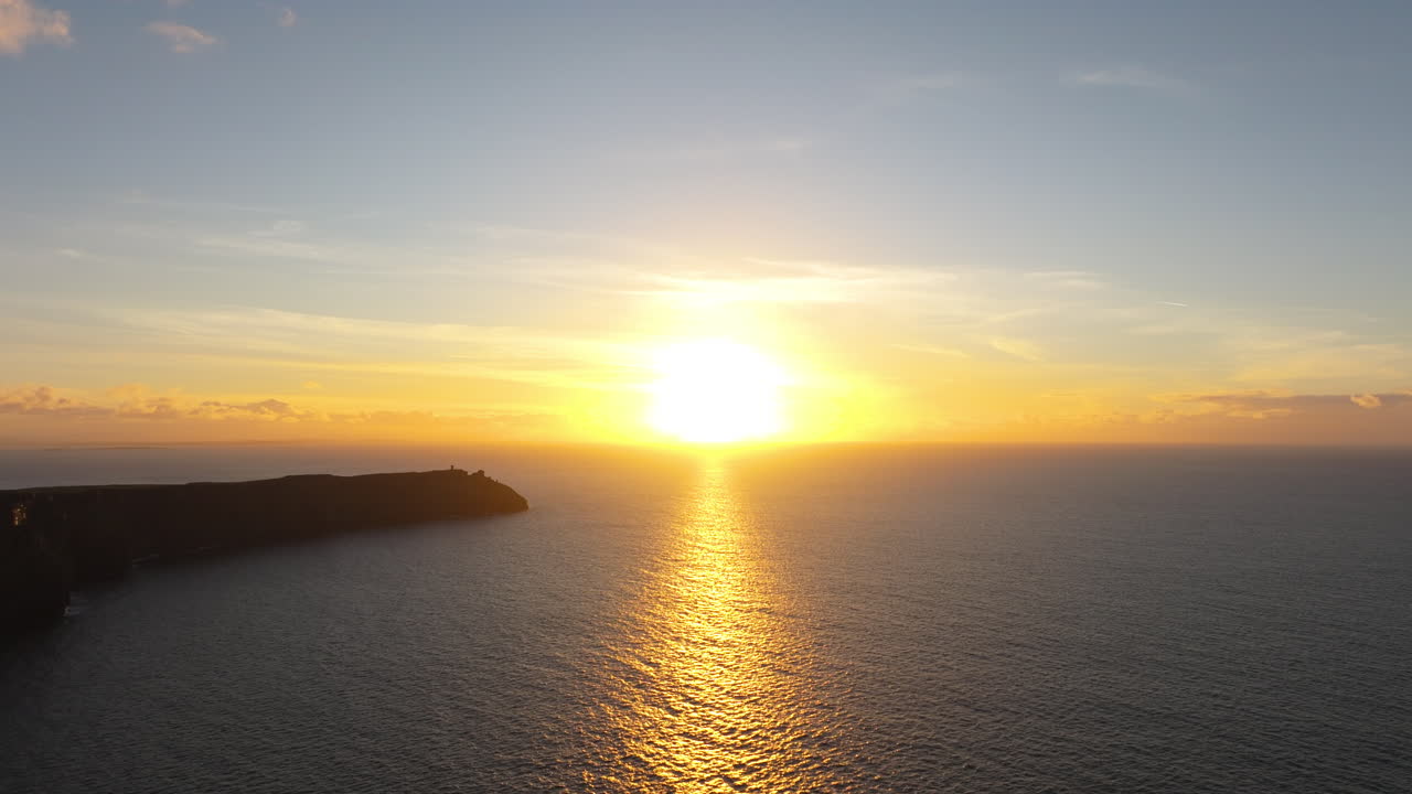 4K aerial drone footage capturing the Cliffs of Moher at sunset, featuring glowing golden-hour colours, Atlantic waves, and breathtaking Irish coastline scenery. Ireland_012
