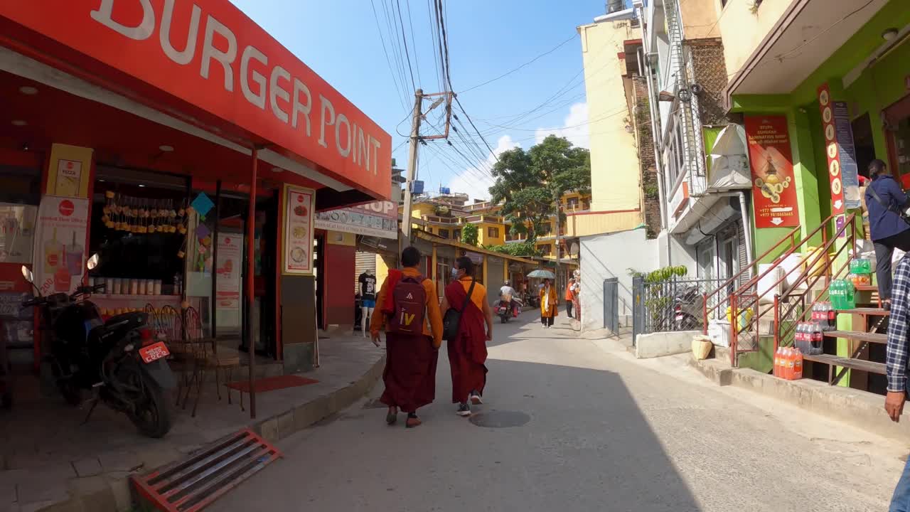 Following Buddhist Monks Walking In The Street To The Boudhanath Stupa In Kathmandu, Nepal. - hyperlapse POV shot