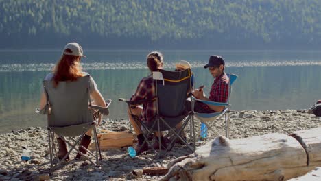 group of hikers camping near riverside 4k