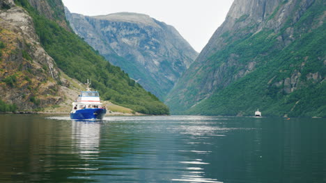 a small cruise ship sails along the picturesque fjord in norway travel and tourism in scandinavia 4k