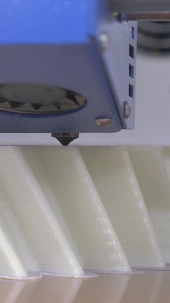 Close-up of 3D Printer Nozzle Manufacturing White Plastic Object