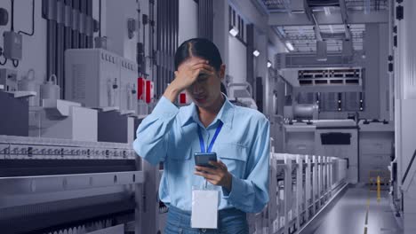asian female with her smarphone at pharmaceutical factory, vaccine production facility, she is nodding her shead with dissapionted