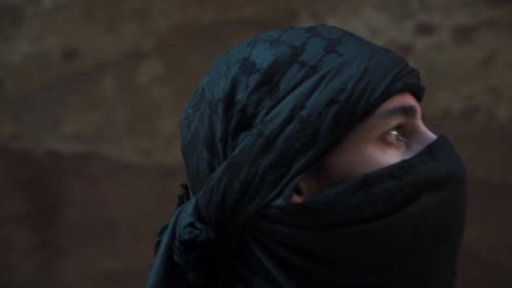 male tourist wearing respectful head cover walking through wadi petra jordan