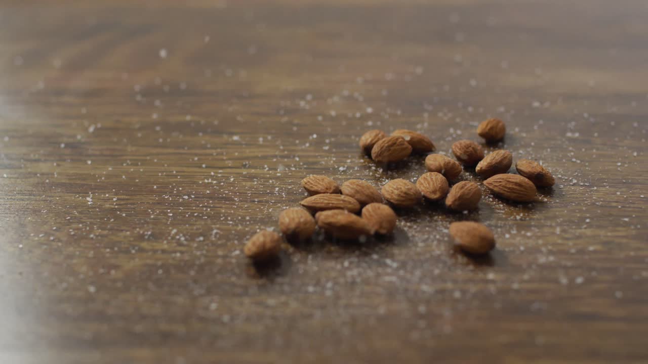 Video of almonds on wooden background