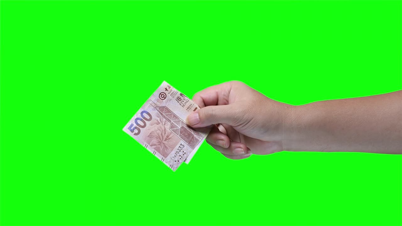 녹색 화면 배경에 고립 된 홍콩 500 달러 지폐를 들고 있는 손