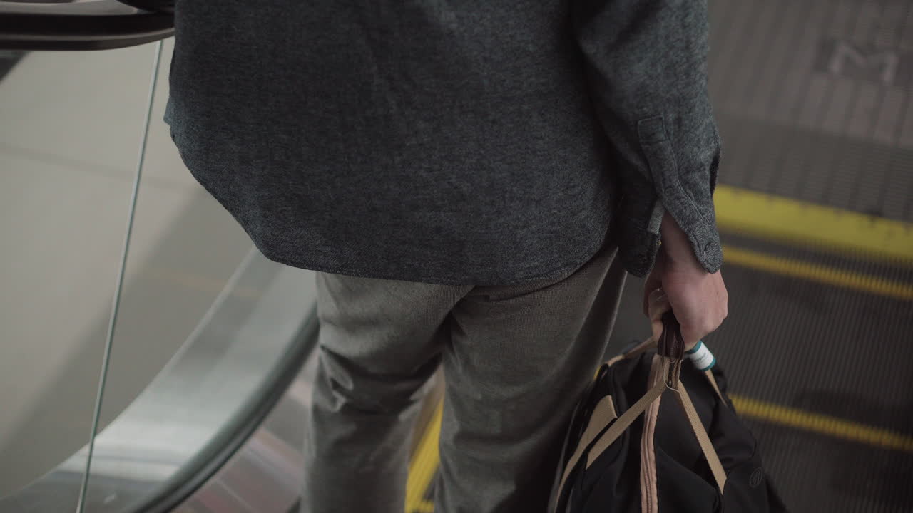 Man using an escalator