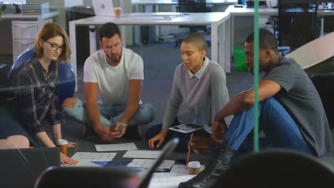 Young-mixed-race-business-team-discussing-over-documents-in-office-4k