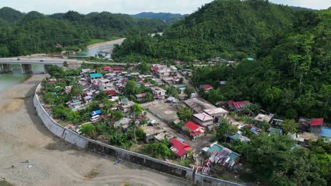 idyllic aerial orbit of santo domingo village alongside lush hills and pajo river in virac, catanduanes