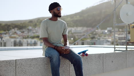 Black-man,-relax-and-rest-on-wall-with-skateboard
