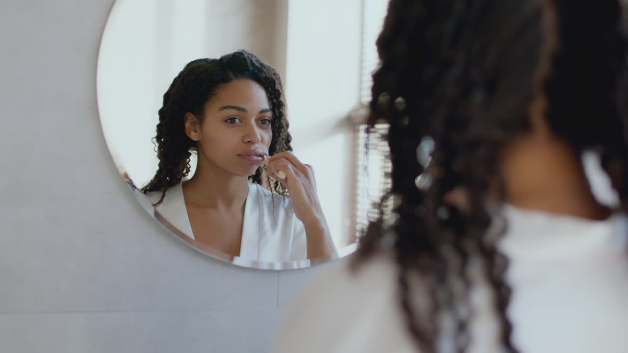 Donna che si lava i denti in bagno