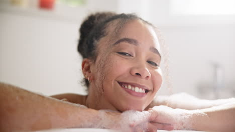 calm, smile and face of a woman in a bubble bath