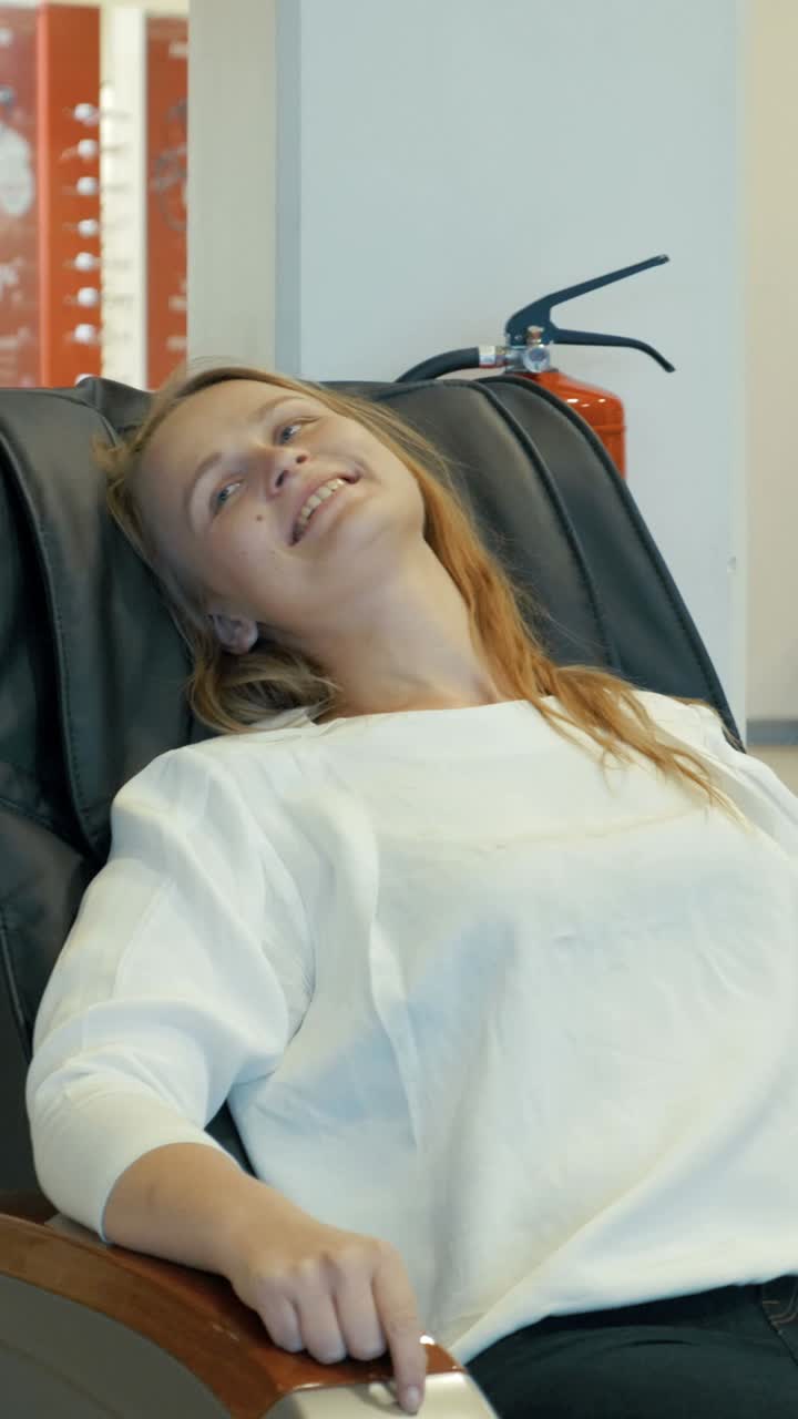 Woman Relaxing in a Massage Chair