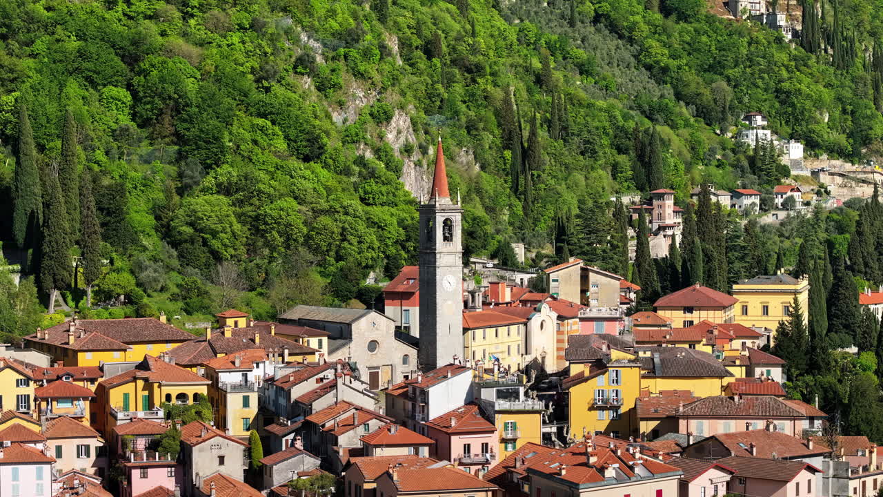 Aerial drone view of Church of S.Giorgio surrounded by houses in Varenna, Italy