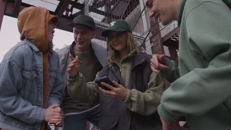 young friends listening to music on the stairs