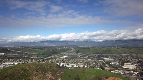 Aerial-views-of-suburban-and-industrial-sprawl-near-green-foothills